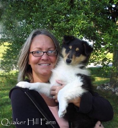 holding a Collie puppy